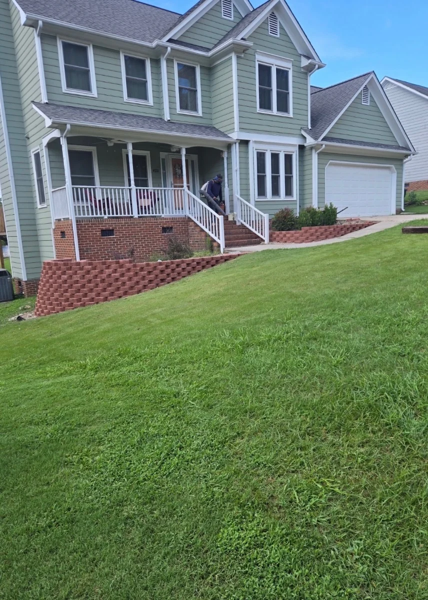 After the North Hills retaining-wall project: red block retaining walls follow the front planting beds on both sides of the steps.